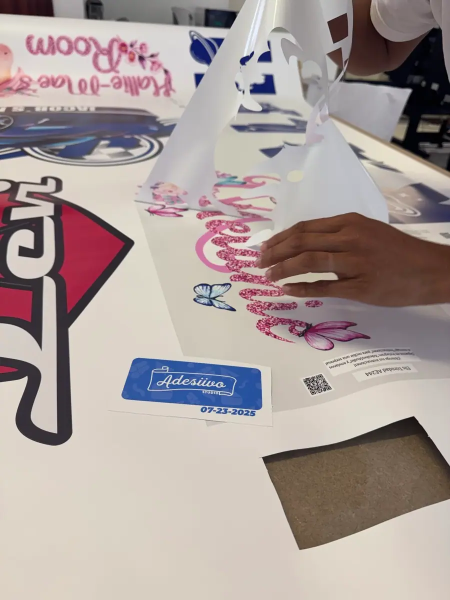 Verificando y cortando vinilos impresos en la mesa de trabajo